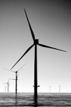 black wind turbines under gray sky