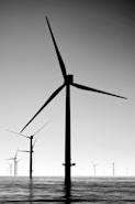 black wind turbines under gray sky