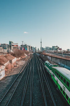 green train on rail during daytime