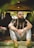 man in white and black stripe polo shirt and gray pants sitting on brown wooden table