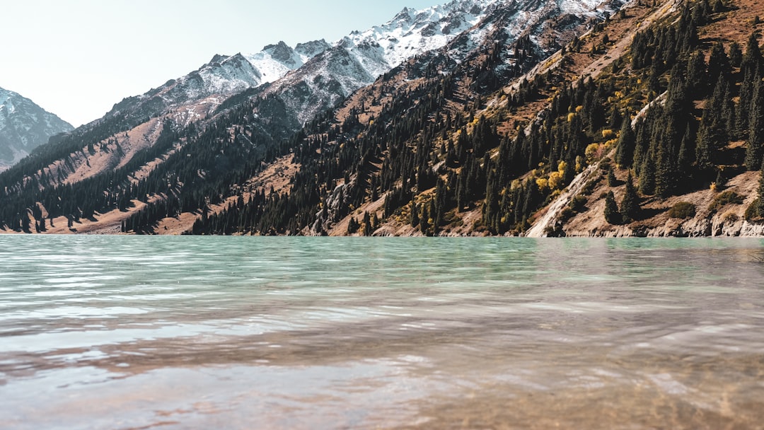 body of water near mountain during daytime in Almaty Region Kazakhstan