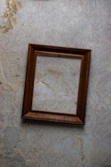 brown wooden frame on white wall