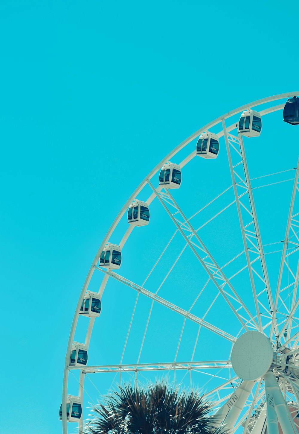 white ferris wheel under blue sky during daytime