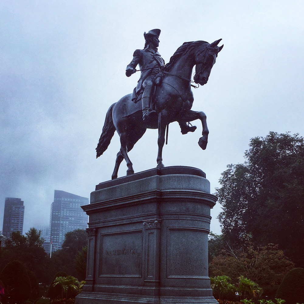 man riding horse statue during daytime