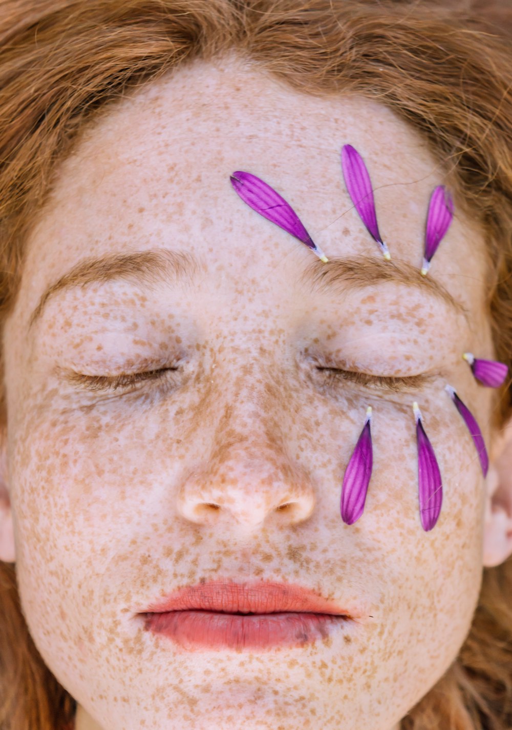 person with purple and pink eye shadow