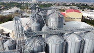 Wide shot of a busy wholesale grain storage facility with workers.