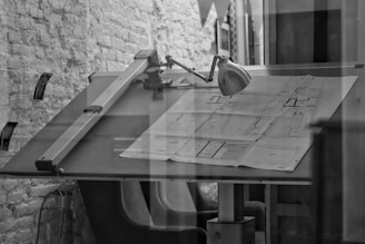 grayscale photo of chair and table
