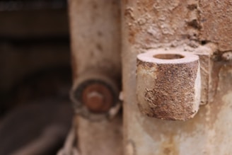 Close-up of laser cleaning rust off a metal surface in an industrial setting.