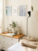 A peaceful bedroom corner featuring a donated dresser and lamp, inviting rest.