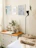 Cozy bedroom corner featuring a rich wooden dresser with natural grain and warm lighting.