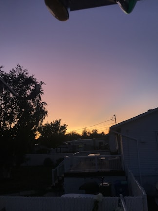Electric generator running quietly in a backyard setting during sunset.