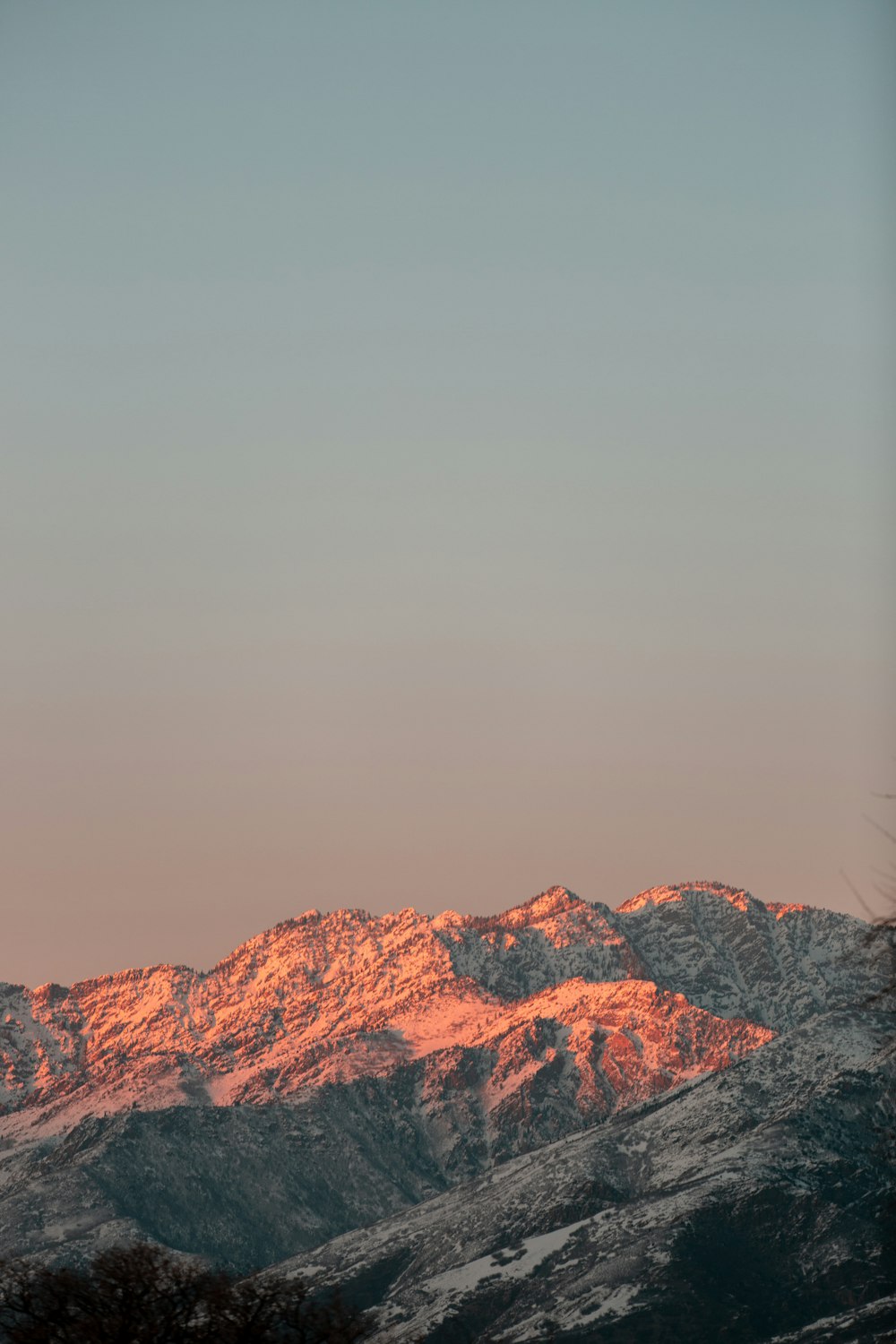 brown rocky mountain under gray sky