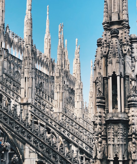 brown concrete building under blue sky during daytime in Milan Cathedral Italy