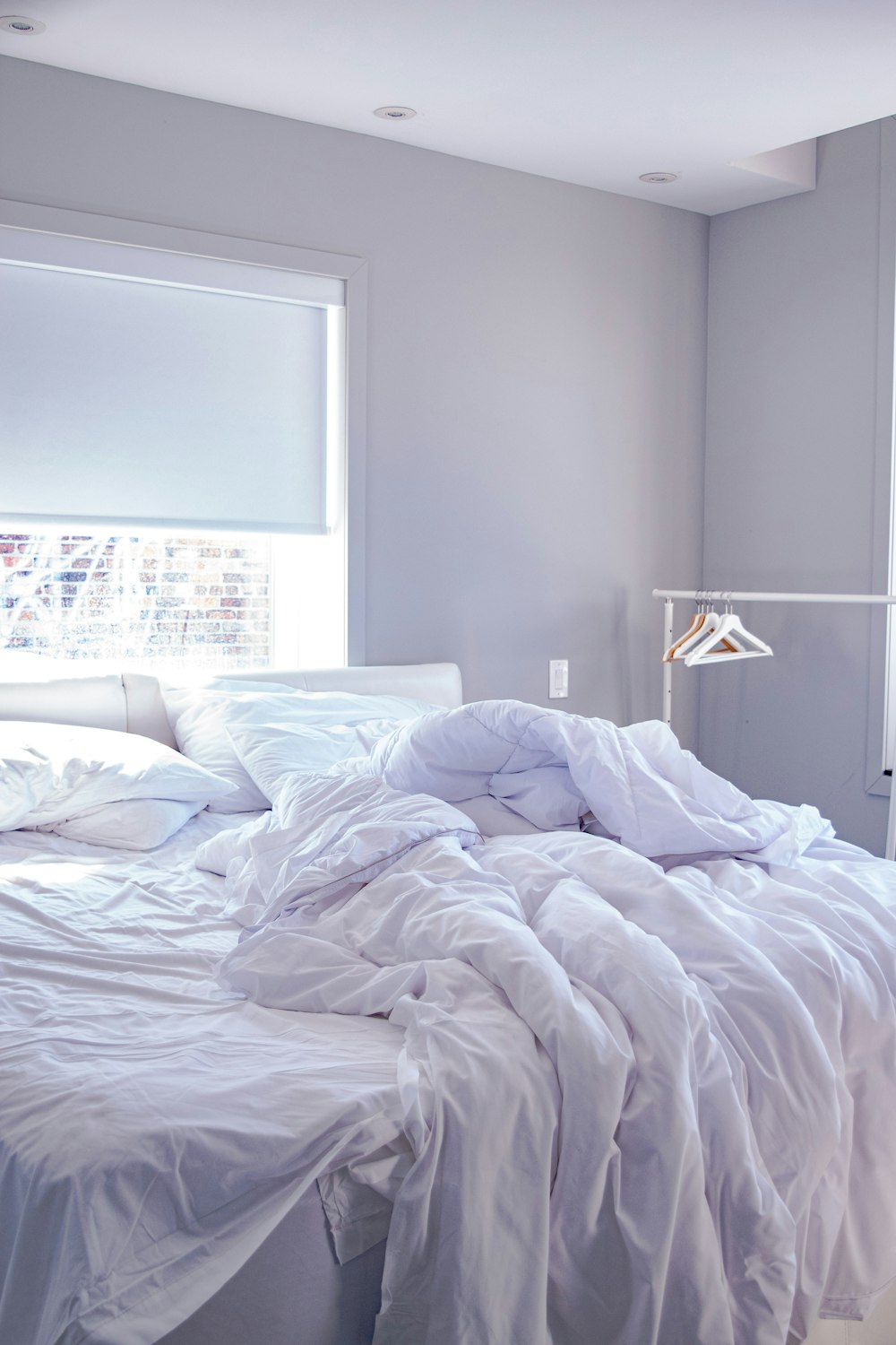 white bed linen on bed