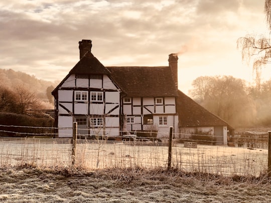 brown and white wooden house under white clouds during daytime in Surrey United Kingdom