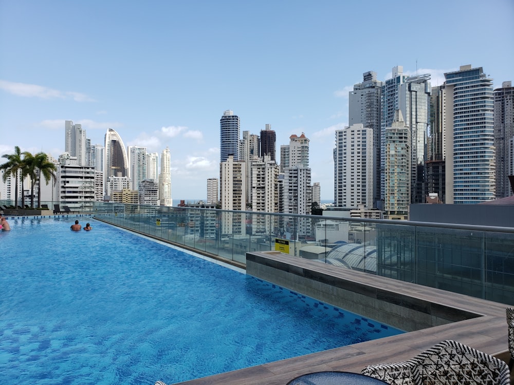 blue swimming pool near city buildings during daytime