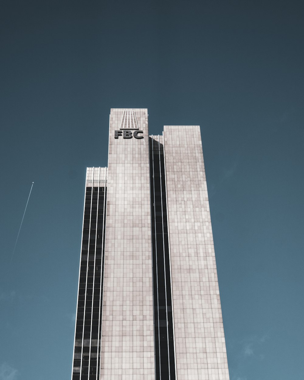 white and black concrete building under blue sky during daytime