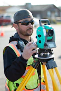 man in black jacket holding blue and black camera