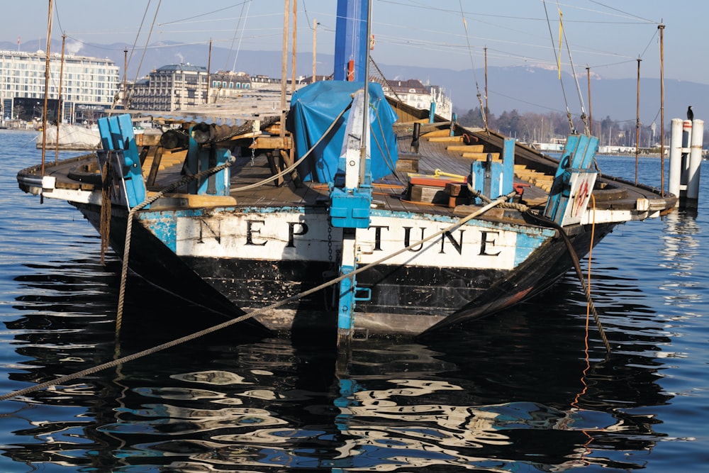 blue and white ship on dock during daytime