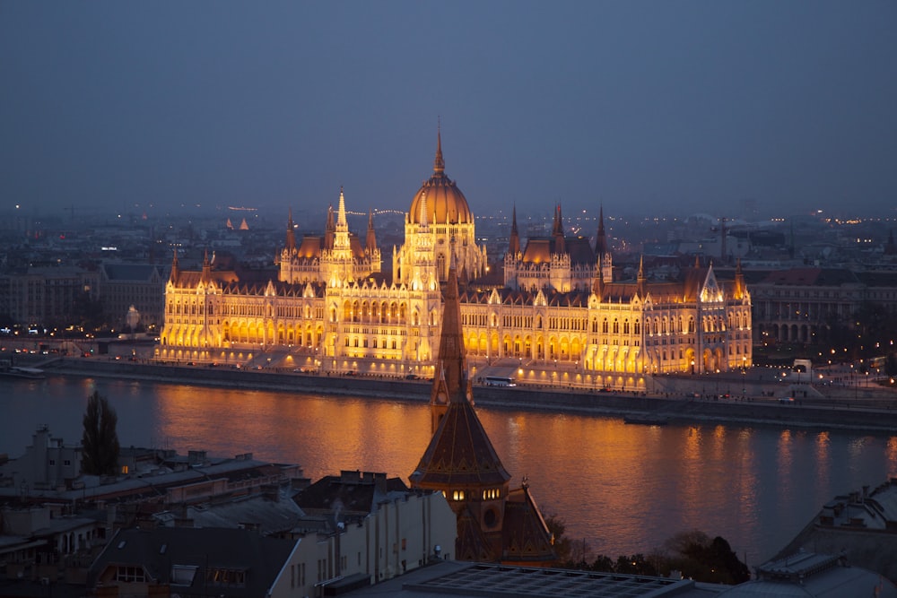 white and brown dome building near body of water during night time