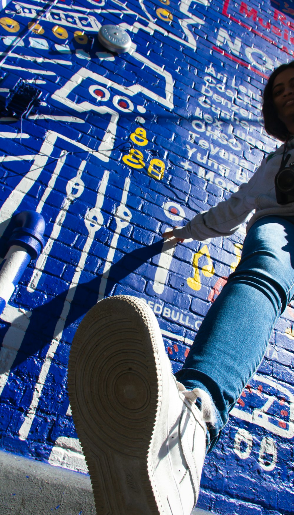 person in blue denim jeans and white sneakers