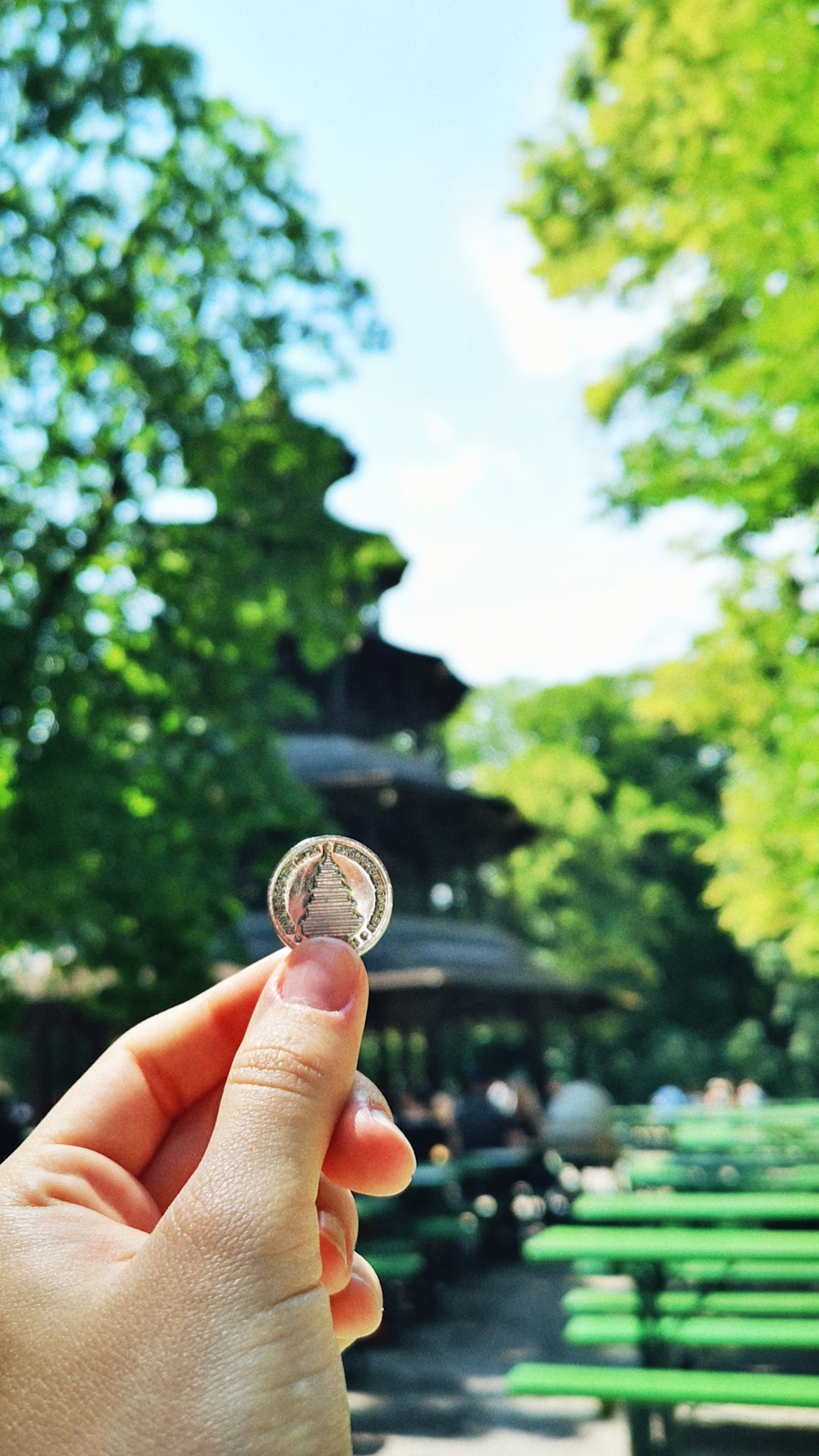 person holding silver round coin