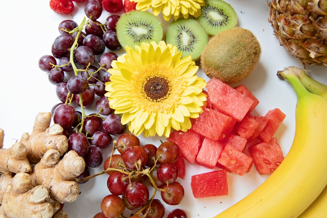 yellow sunflower beside red grapes