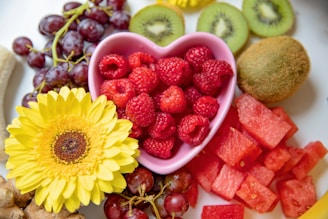 strawberries and yellow sunflower in white ceramic bowl