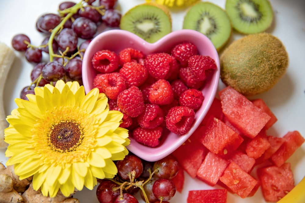 strawberries and yellow sunflower in white ceramic bowl