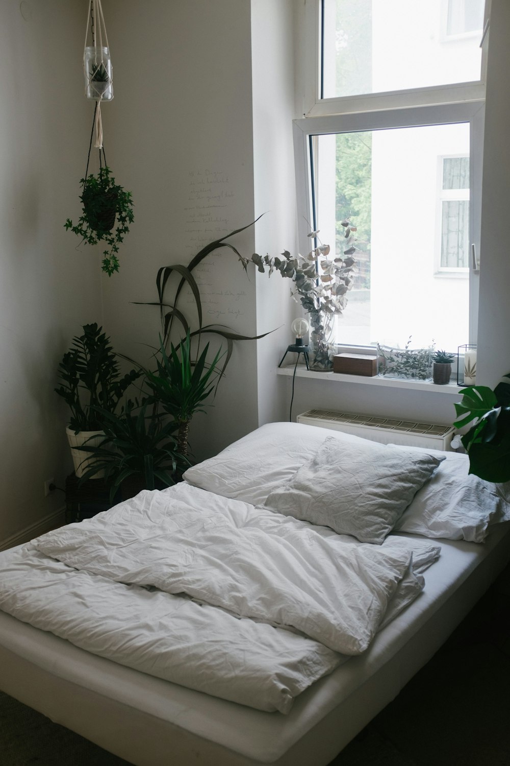 green potted plant on white bed