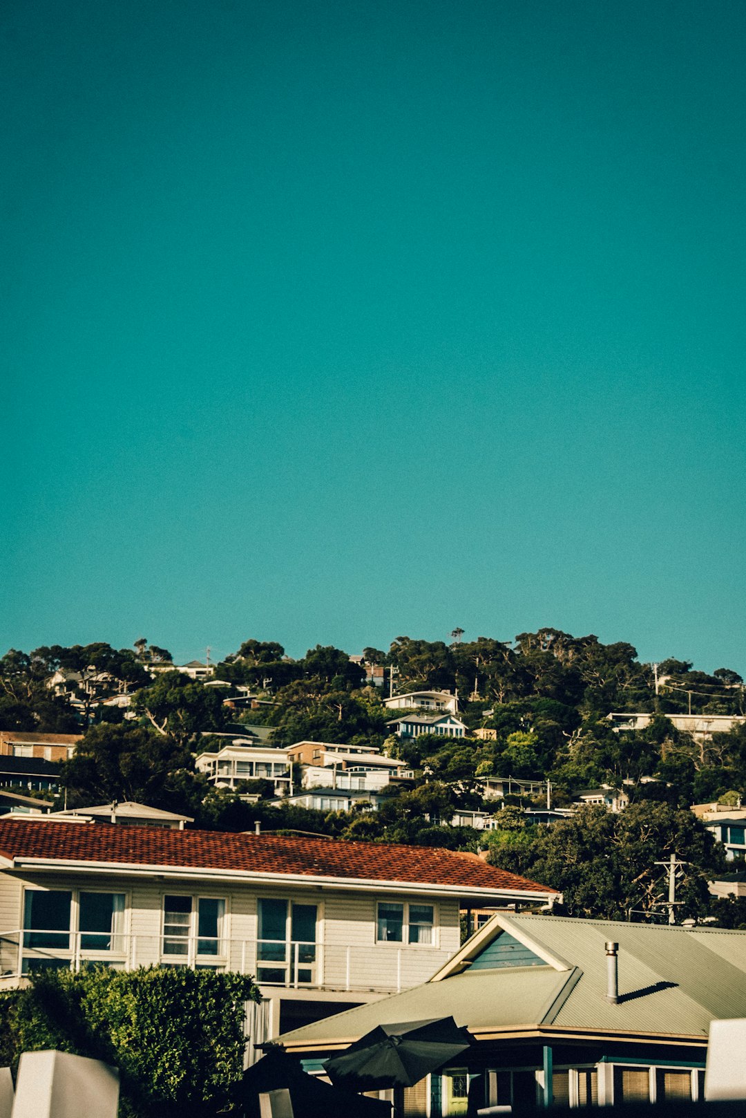 brown and white concrete house under blue sky during daytime