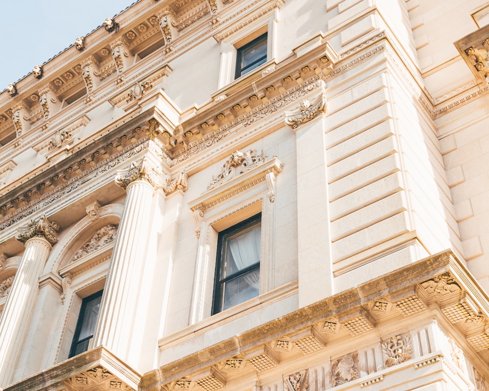 low angle photography of beige concrete building