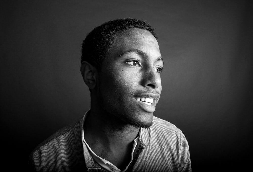 grayscale photo of man in collared shirt