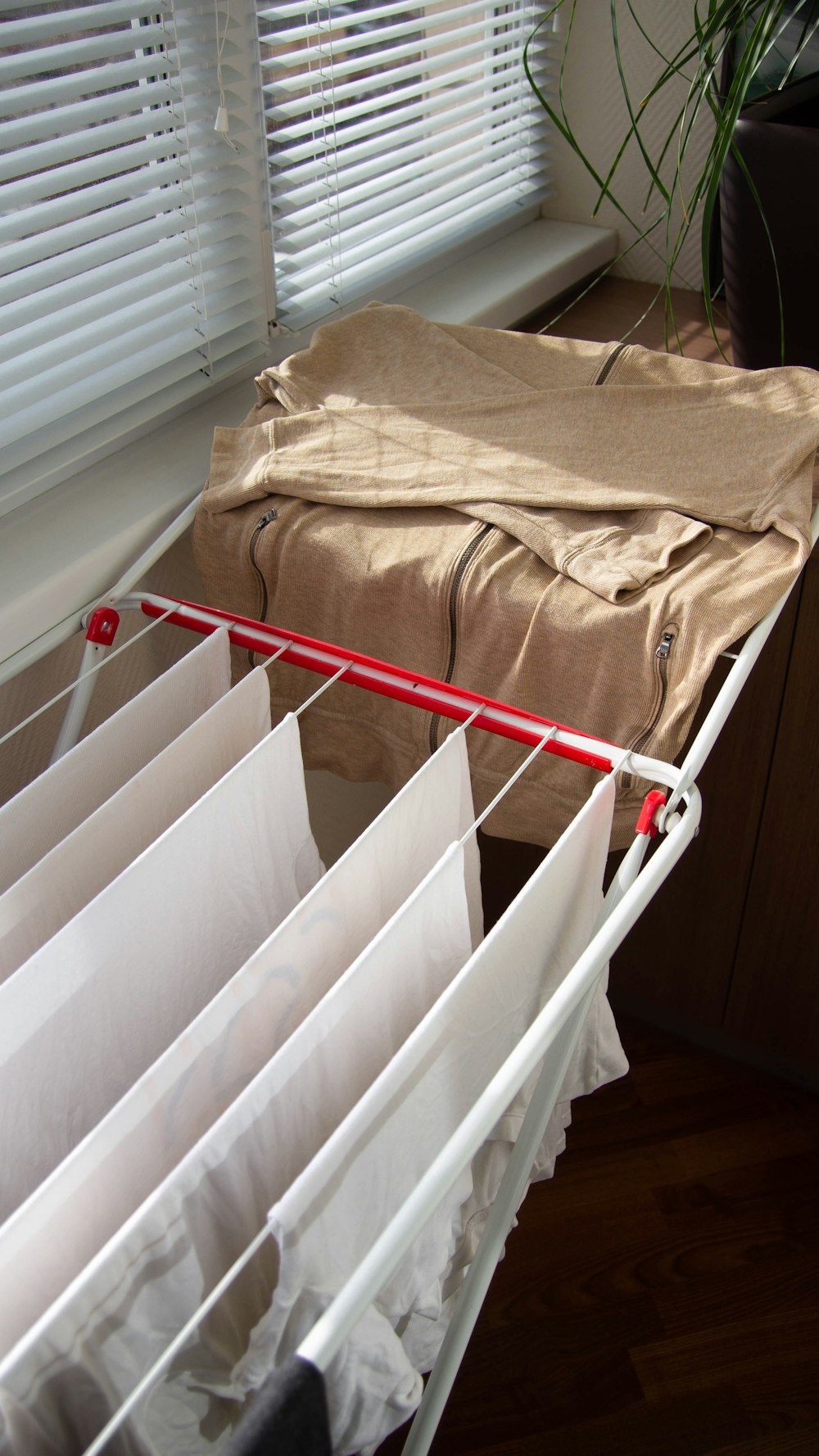 brown textile on white plastic clothes hanger