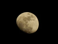 The moon’s surface details captured with craters illuminated by sunlight.