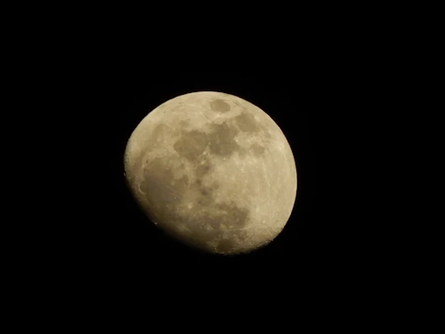 A detailed shot of the moon’s craters illuminated by sunlight.