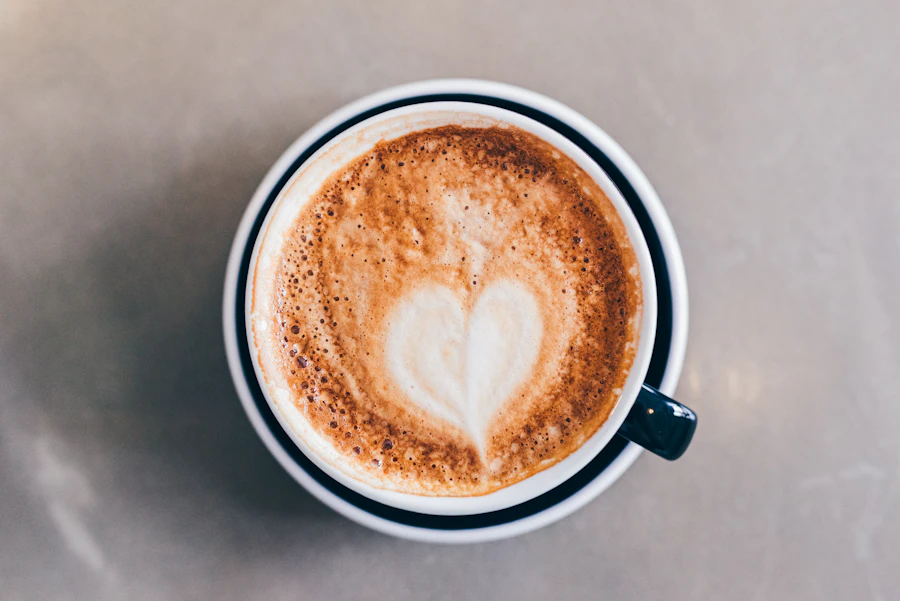Flat white in a white ceramic cup with latte art on a grey surface