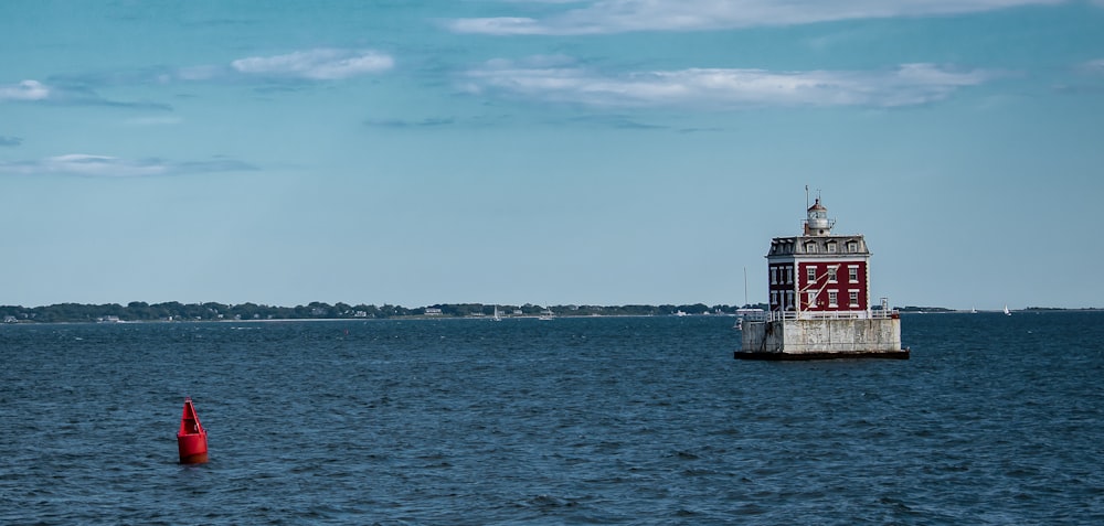 white and red ship on sea under blue sky during daytime