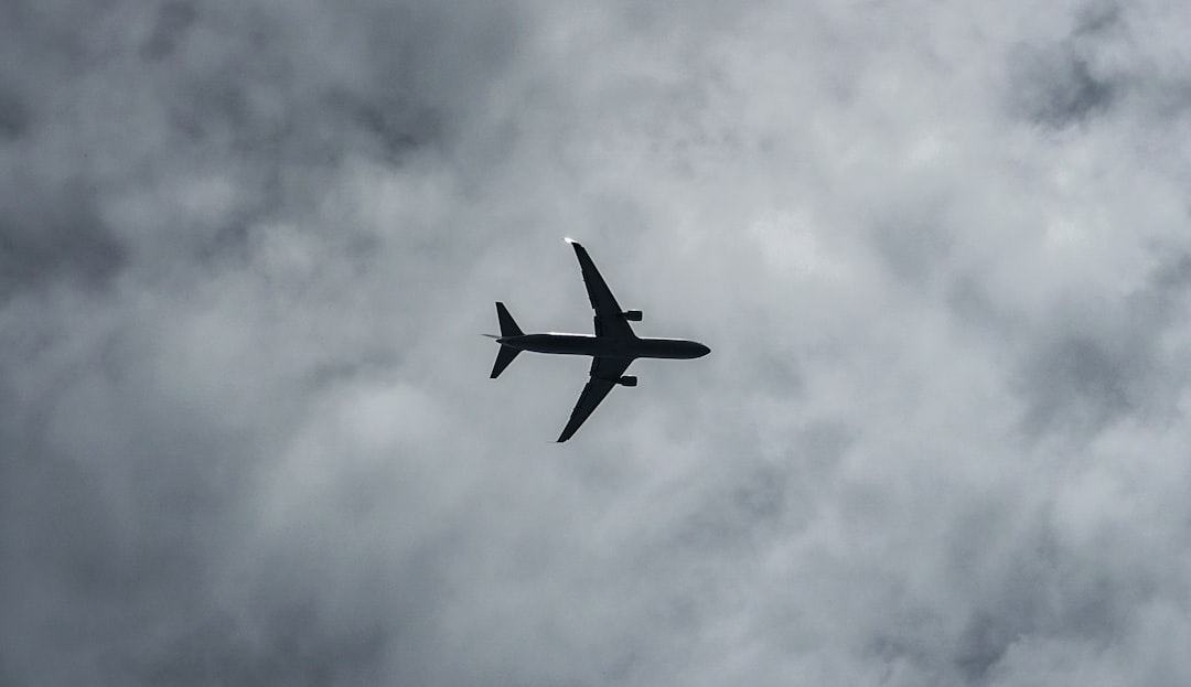 white airplane flying in the sky