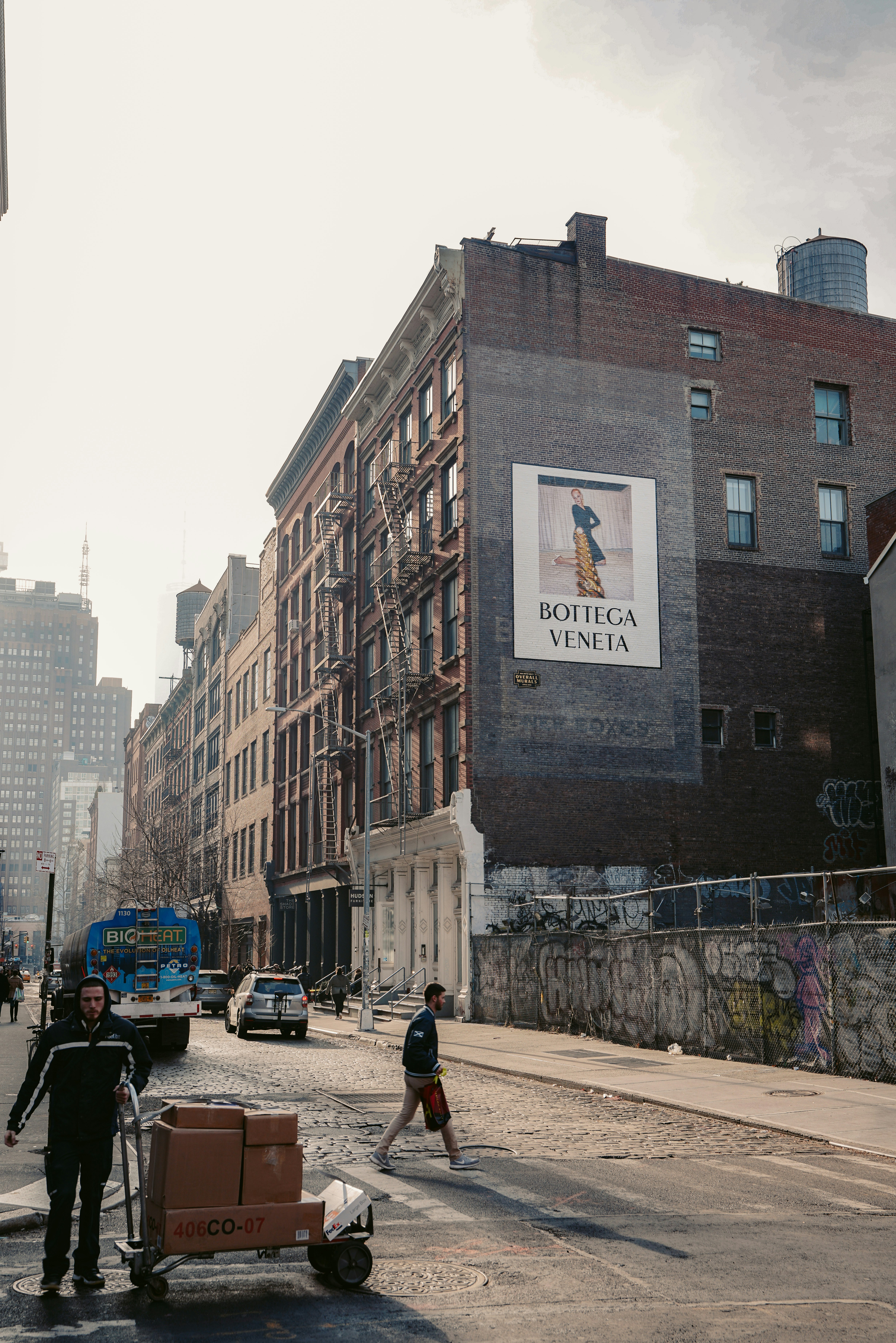 people walking on sidewalk near brown concrete building during daytime