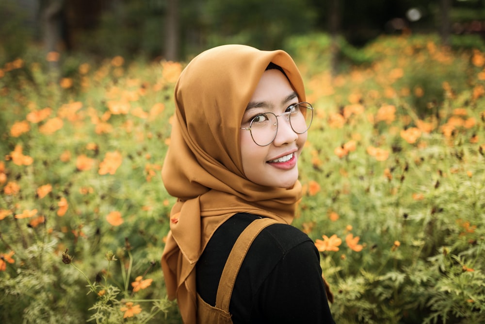 woman in brown hijab and black framed eyeglasses