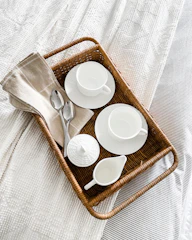 Neatly arranged tea and coffee setup on a small table.