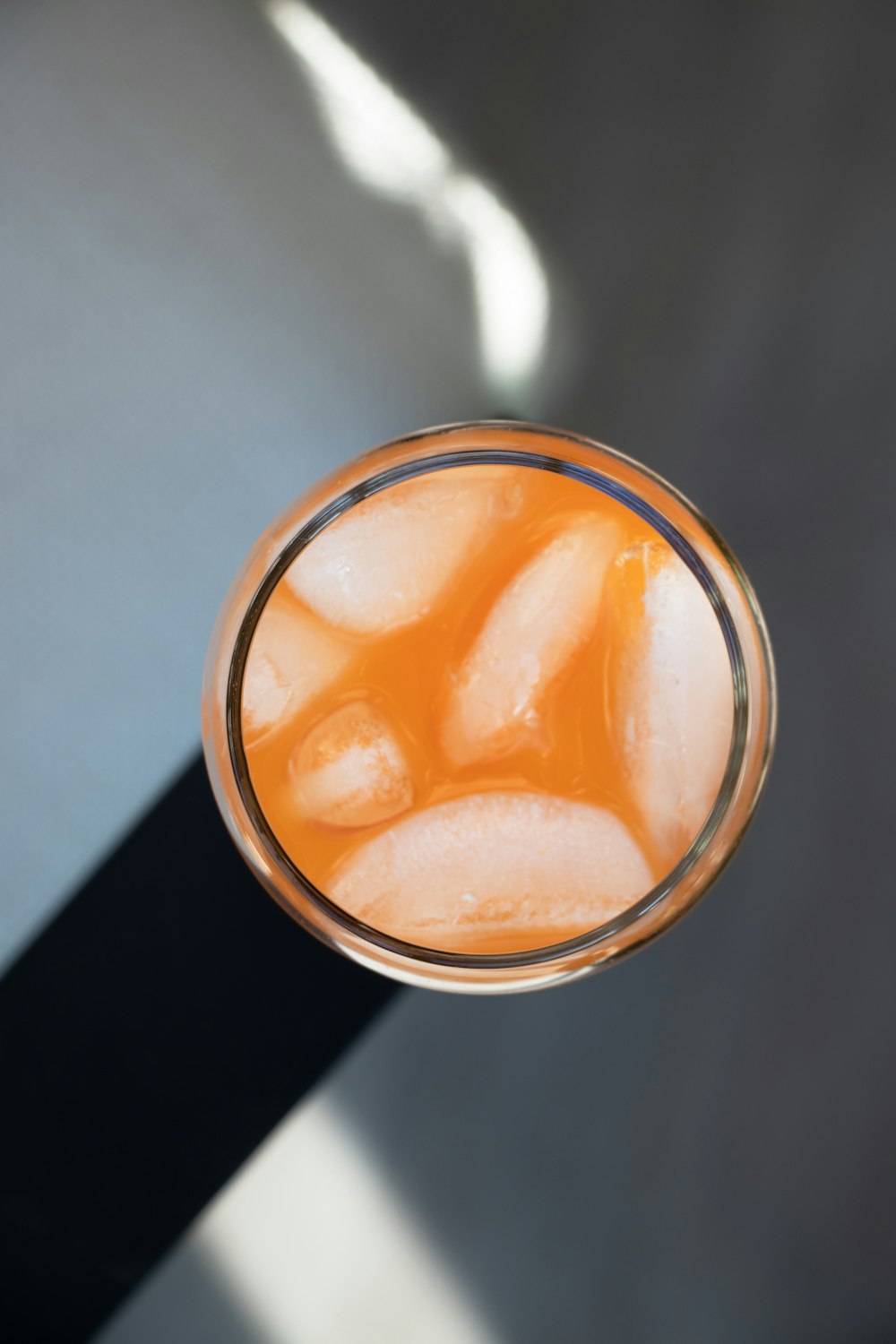 clear drinking glass with orange liquid