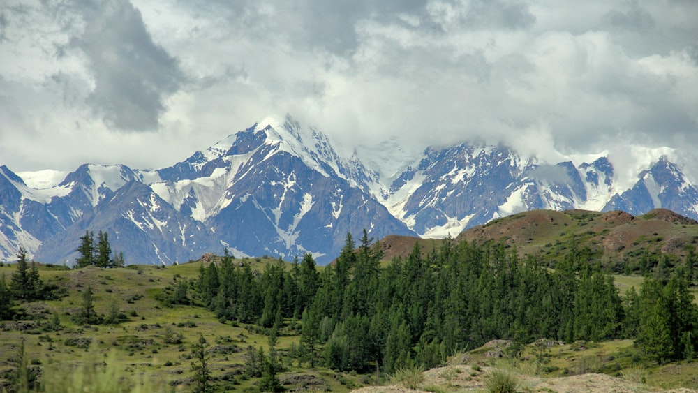 snow covered mountain under cloudy sky during daytime