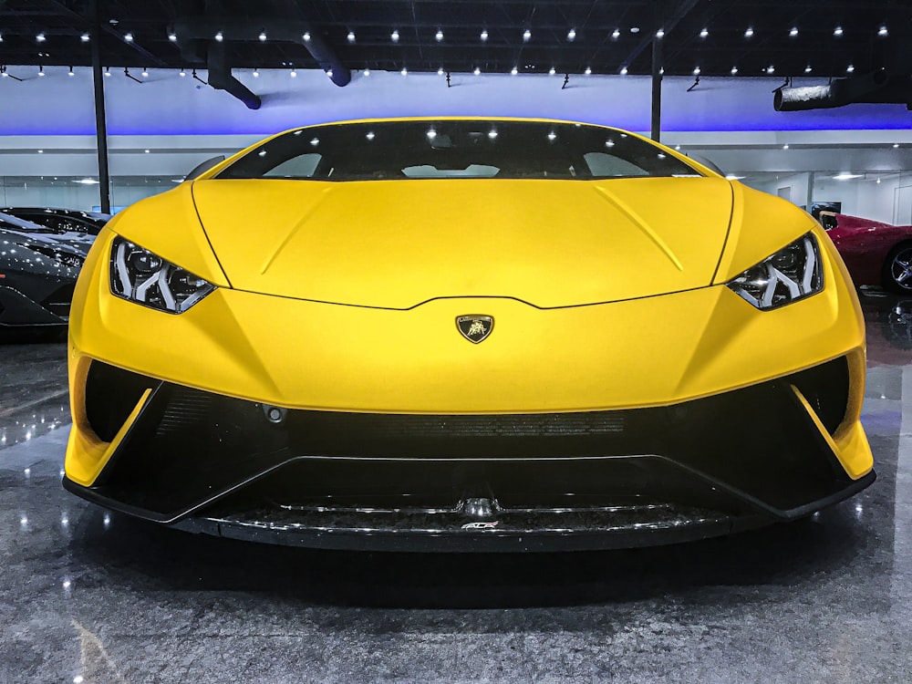 yellow lamborghini aventador parked on parking lot