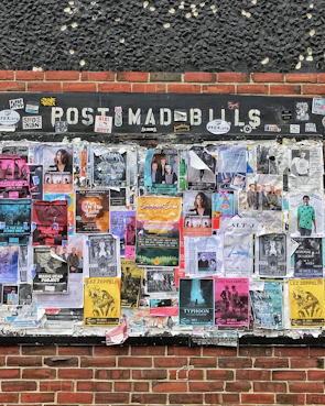 A colorful bulletin board filled with local event flyers and classifieds.