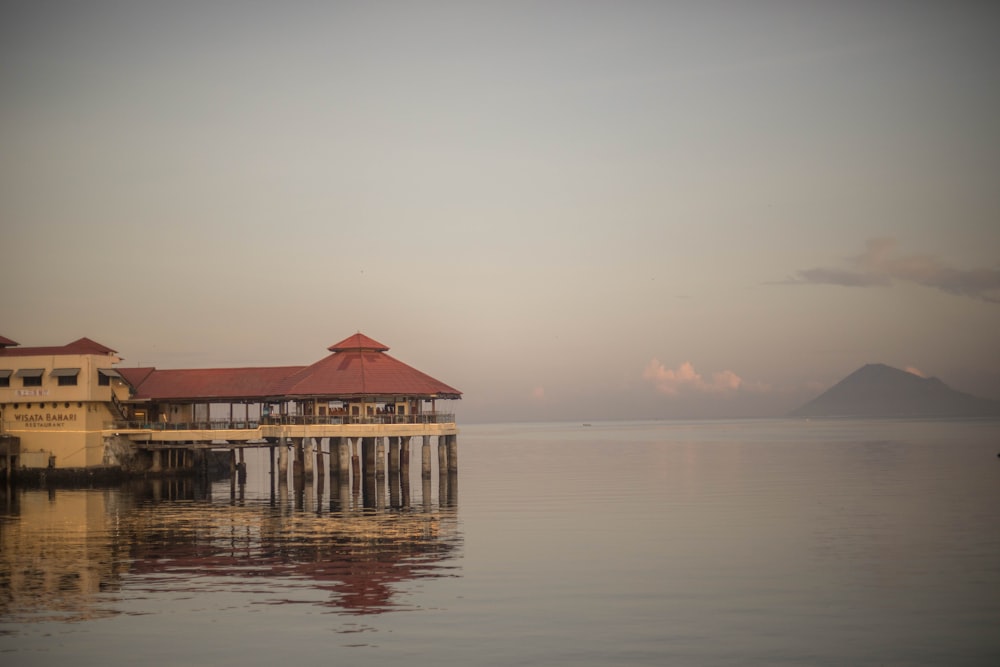 brown wooden house on body of water during daytime