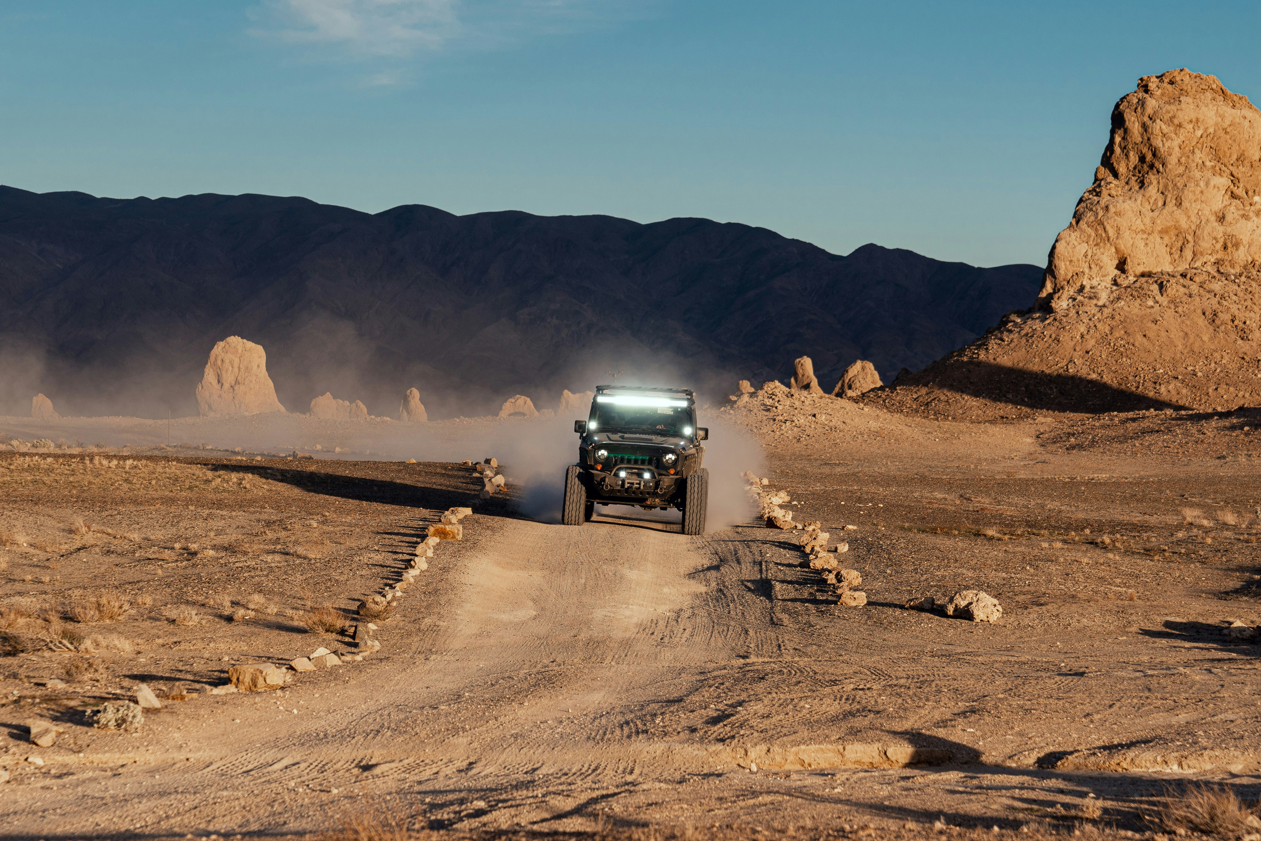 black suv on brown sand during daytime