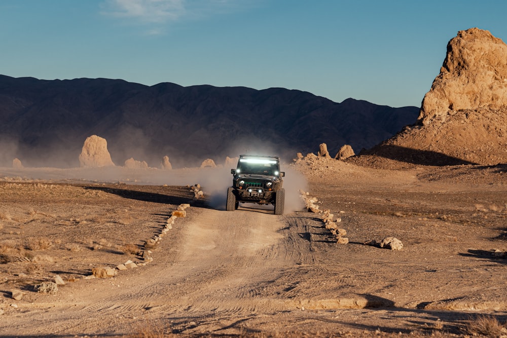 black suv on brown sand during daytime