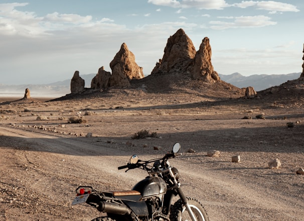 black motorcycle on brown dirt road during daytime